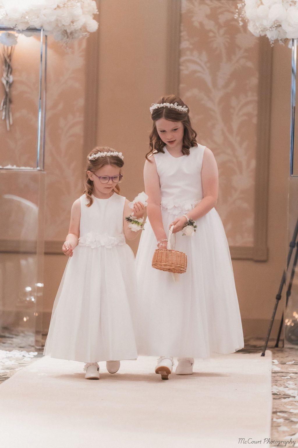 Flower girls walking down the isle at the dalziel park hotel