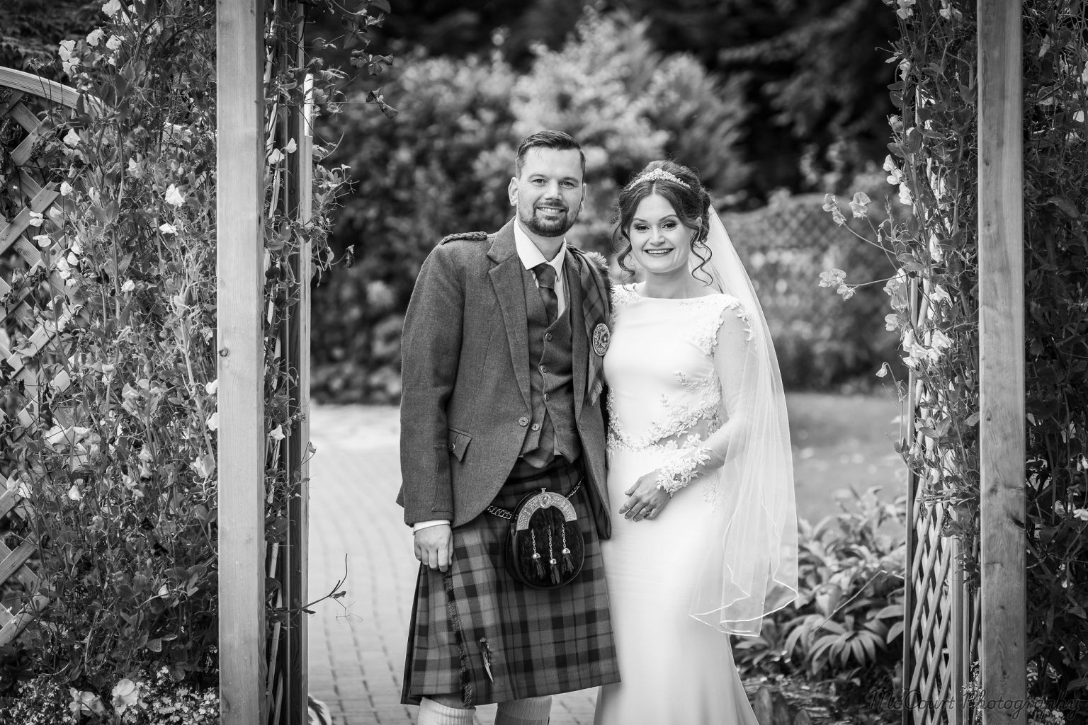 Black and white picture of Sarah and Patrick newlyweds at the dalziel park hotel